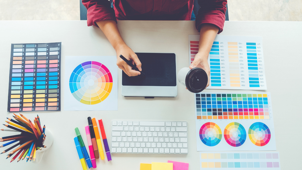 Graphic Designer seated at her desk, working on a client project. 